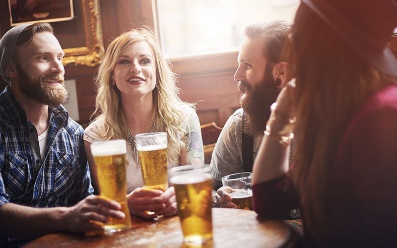 Pub bar beer friends chatting istock